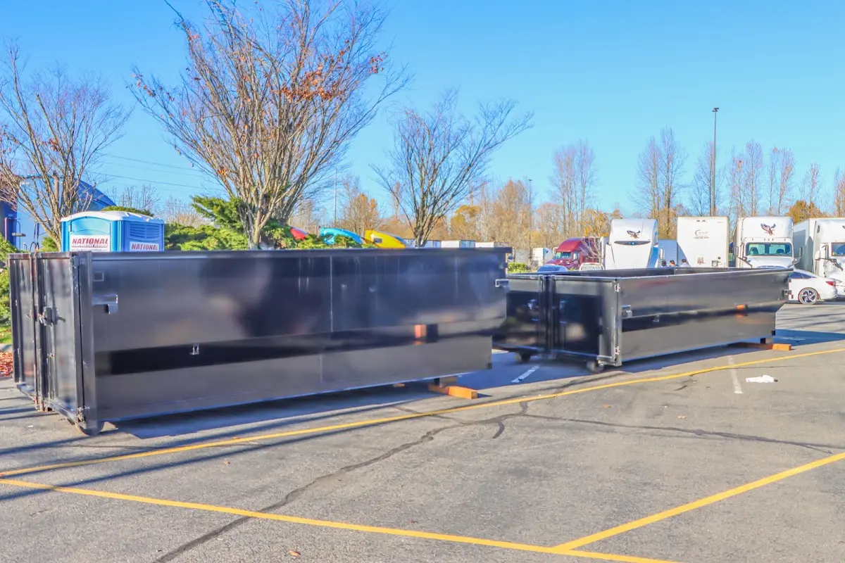 Professional dumpster rental service with roll-off container on residential driveway in Doylestown